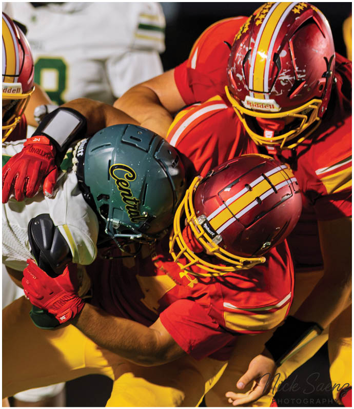 A football player in a white jersey with the number 2 on it is running with the ball. Description generated by AI