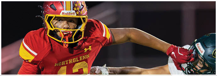 A football player in a black jersey is tackling another player. Description generated by AI