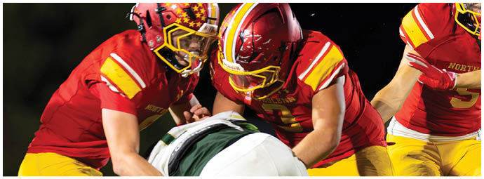 A group of football players celebrating a touchdown. Description generated by AI