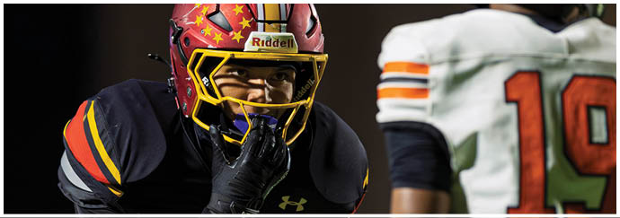 A football player in a black jersey is tackling another player. Description generated by AI