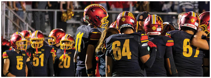 A group of football players celebrating a touchdown. Description generated by AI