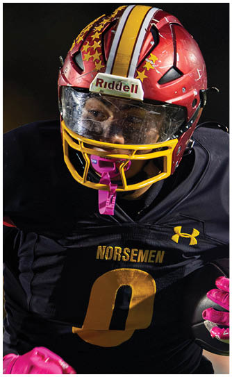 Two football players wearing white uniforms with red and yellow stripes. Description generated by AI