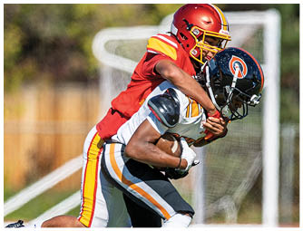 A football player wearing a red helmet and white jersey with the number 7. Description generated by AI