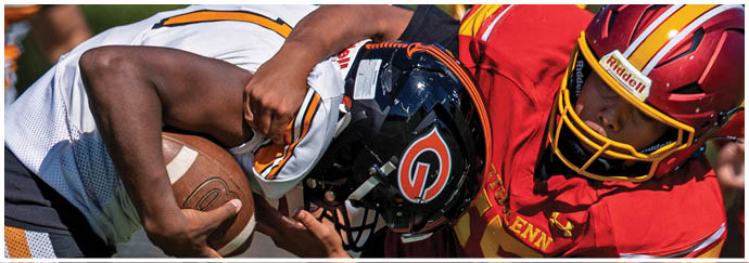 A football player in a black jersey is tackling another player. Description generated by AI