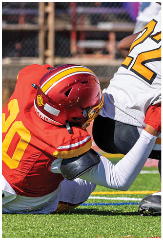 A football player wearing a red and white jersey with the number 9 on it. Description generated by AI