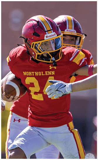 A football player wearing a red and white jersey with the number 8 on it. Description generated by AI