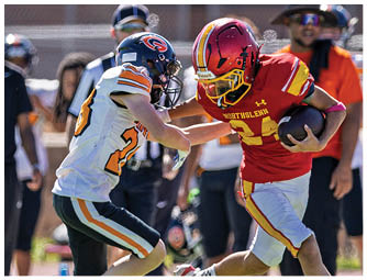 A football player wearing a red helmet and white jersey with the number 7. Description generated by AI