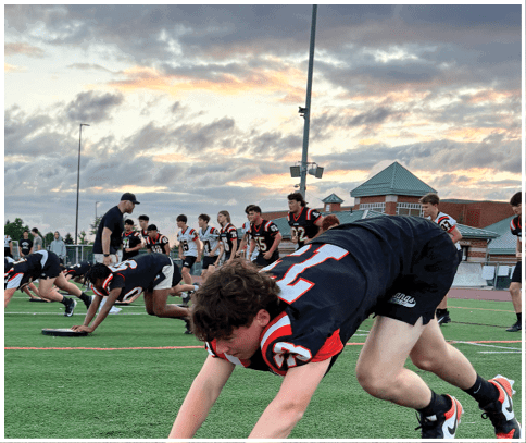 A football game is being played on a field. Description generated by AI
