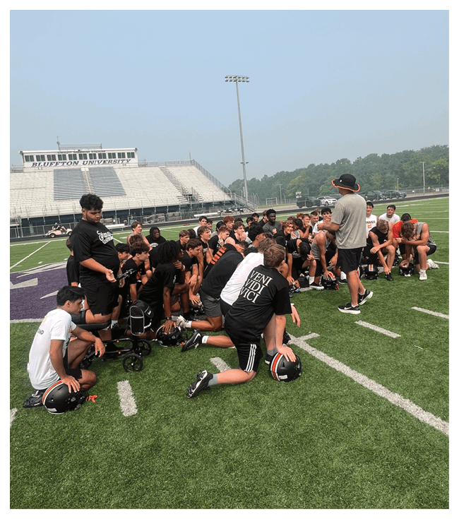 A group of football players walking on the field. AI generated content