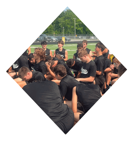 A football player wearing a black jersey with the number 3 kneels on the field. AI generated content