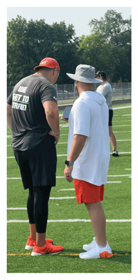A man in a green shirt and black pants is preparing to throw a football. AI generated content