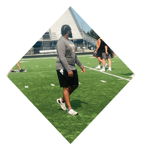 A football player wearing a black jersey with the number 16 on it is holding a football. AI generated content