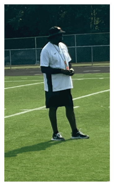 A football player wearing a black and white uniform with the number 10 on the back. AI generated content