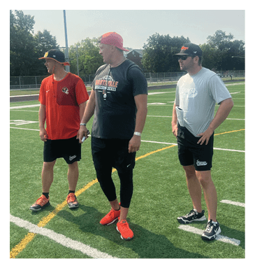 Two men wearing football helmets are talking to each other. AI generated content