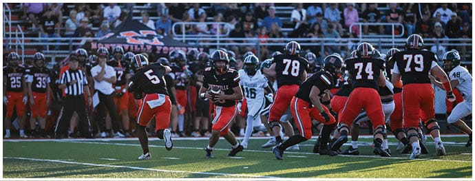 A football player is sliding on the ground. Description generated by AI