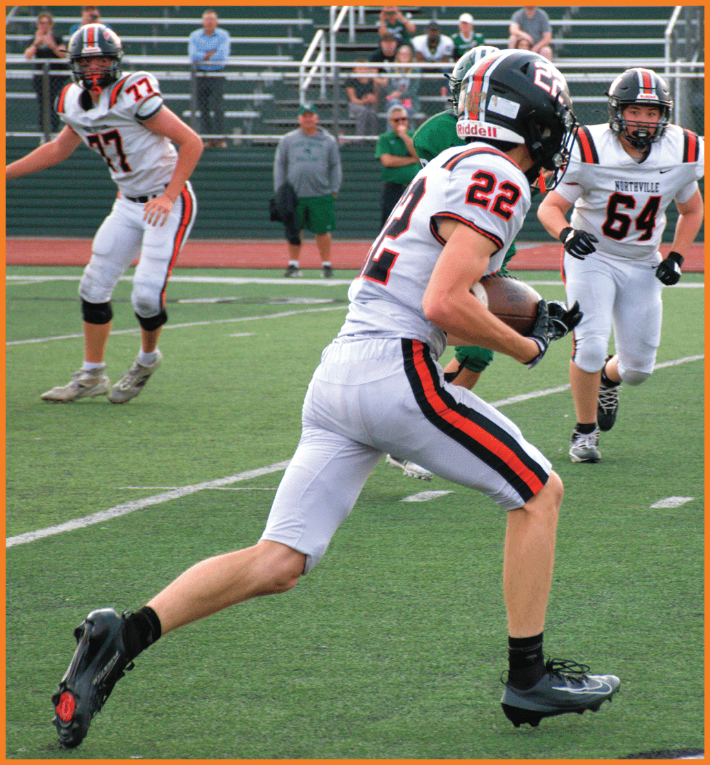 A football player running on the field. Description generated by AI