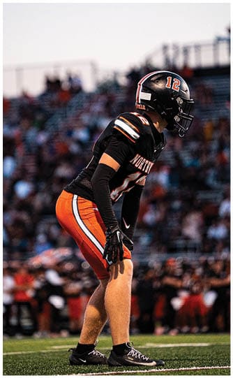 A football player is sliding on the ground. Description generated by AI