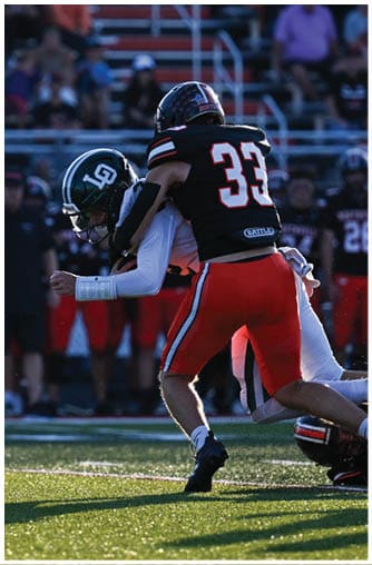A football player running on the field. Description generated by AI