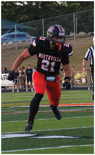 A football player is sliding on the ground. Description generated by AI