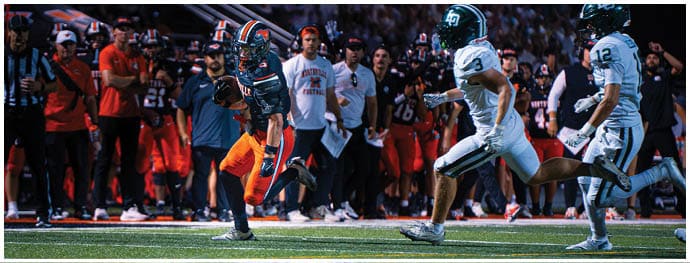 A football player is sliding on the ground. Description generated by AI