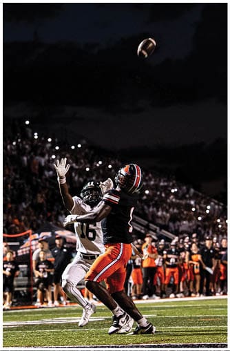 A football player running on the field. Description generated by AI