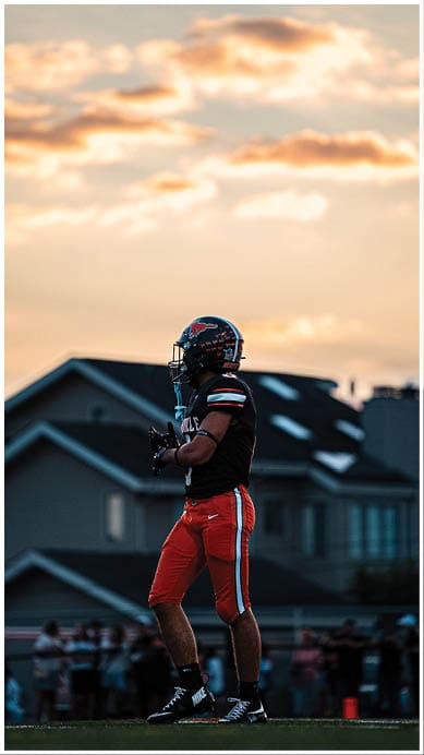 A football player wearing a blue jersey with the number 58 on it. Description generated by AI
