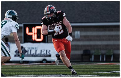 A football player wearing a blue jersey with the number 58 on it. Description generated by AI