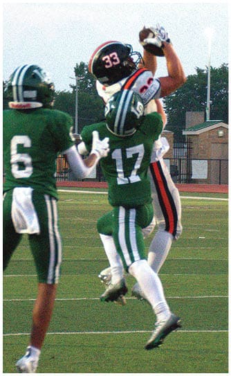 A football player catching a ball. Description generated by AI