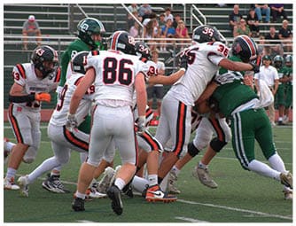 A group of football players on a field. Description generated by AI