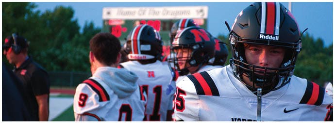 A football player wearing a blue and white uniform. Description generated by AI