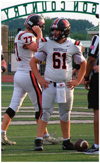 A football player catching a ball. Description generated by AI