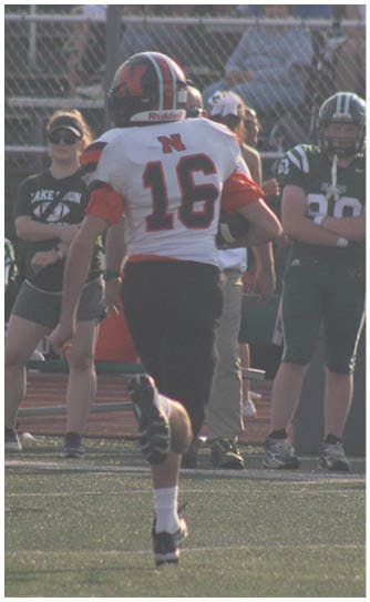 A football player catching a ball. Description generated by AI
