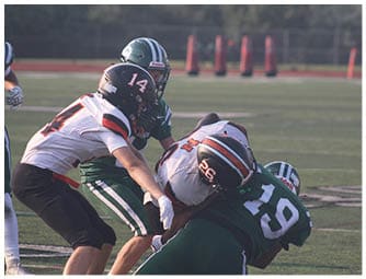 A group of football players on a field. Description generated by AI
