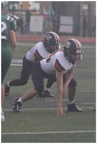 A football game is being played on a field. Description generated by AI