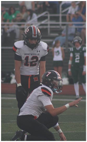 A football player catching a ball. Description generated by AI