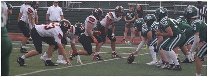 A football player wearing a blue and white uniform. Description generated by AI