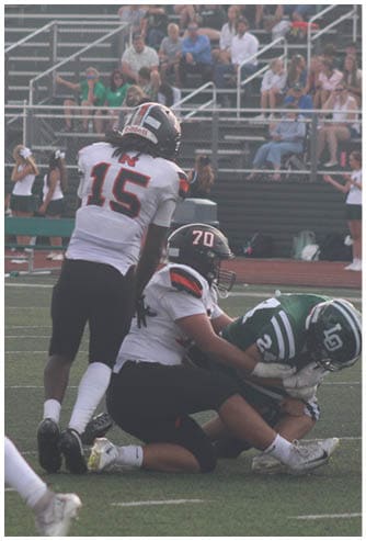 A football game is being played on a field. Description generated by AI