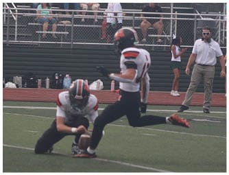 A group of football players on a field. Description generated by AI