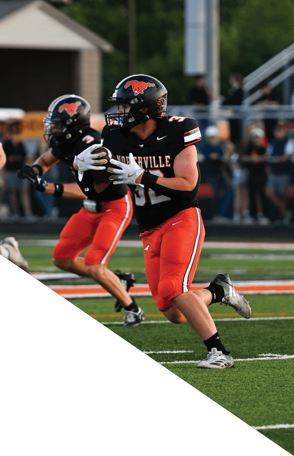 A football player is kneeling on the field, holding his helmet in his hands. AI generated content
