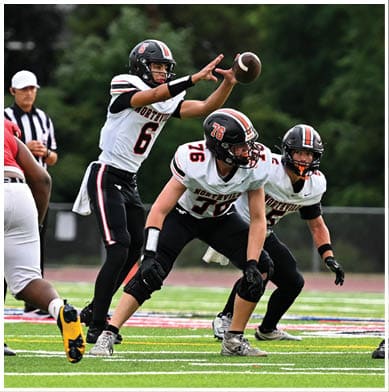 A football player running on the field. Description generated by AI
