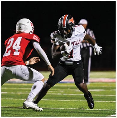 A football player running on the field. Description generated by AI