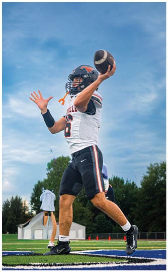 A football player is sliding on the ground. Description generated by AI