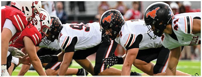 A football player is sliding on the ground. Description generated by AI