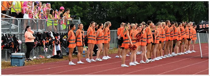 A group of football players on a field. Description generated by AI