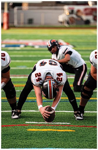 A football player running on the field. Description generated by AI