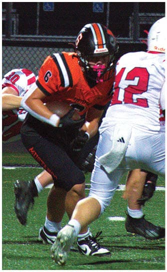 A football player catching a ball. Description generated by AI