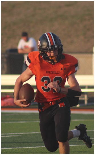 A football player catching a ball. Description generated by AI