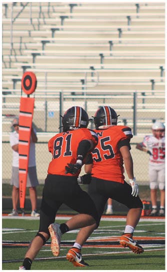 A football player catching a ball. Description generated by AI