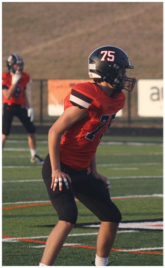 A football player catching a ball. Description generated by AI