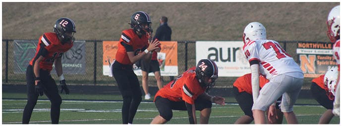 A football player wearing a blue and white uniform. Description generated by AI